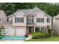 Charming two-story home featuring a brick-and-siding facade, manicured landscaping, and a welcoming two-car garage at 5415 Old Haven Ct, Cumming, GA 30041