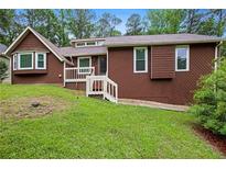 Charming single-Gathering home with a well-manicured lawn, inviting bay window and a classic, brown exterior at 3492 Ember St, Marietta, GA 30066