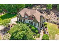 Aerial view of a two-story home featuring manicured landscaping and a well-maintained lawn at 112 Pebblebrooke Run, Canton, GA 30115