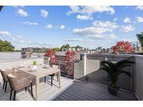 Enjoy city views from this rooftop deck with wooden floors, dining table, and space for entertaining at 238 Walker # 39, Atlanta, GA 30313