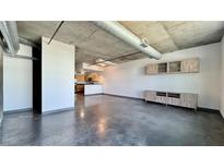 Open floor plan features concrete ceilings and floors, along with a spacious living area and modern fixtures at 115 W Peachtree Nw Pl # 709, Atlanta, GA 30313