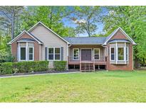 Charming ranch-style home with a well-maintained lawn and inviting front porch at 4805 Forest Way Ct, Marietta, GA 30066