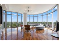 Bright living room features floor-to-ceiling windows and hardwood floors at 222 12Th Ne St # 1806, Atlanta, GA 30309