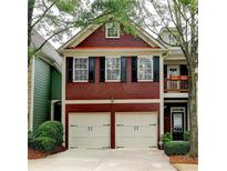 Charming two-story home with red siding, black shutters, and a two-car garage at 2695 Ridge Run Trl, Duluth, GA 30097