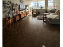 Bright living room features parquet floors, large windows, and comfortable seating at 3060 Pharr N Ct # 607, Atlanta, GA 30305