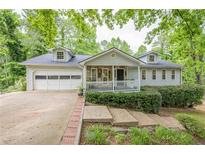 Charming home featuring a stone front porch and attached garage at 2663 Marcia Dr, Lawrenceville, GA 30044