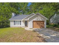 Charming single-story home with vinyl siding, an attached garage, and a well-maintained front yard at 785 Redland Dr, Jonesboro, GA 30238