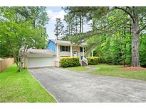 Charming home with a well-maintained lawn and a spacious driveway, perfect for Gathering living at 3003 Butler Creek Nw Rd, Kennesaw, GA 30152