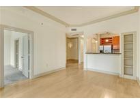 Bright, open-concept living room with hardwood floors and an archway to the kitchen at 3445 Stratford Ne Rd # 305, Atlanta, GA 30326