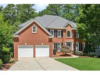 Charming two-story brick home with a well-manicured lawn and a two-car garage at 4058 Vinings Mill Se Trl, Smyrna, GA 30080