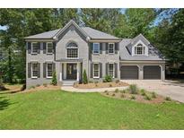 Charming two-story home with gray brick, black shutters, and a well-manicured front lawn at 5702 Brynwood Nw Cir, Acworth, GA 30101
