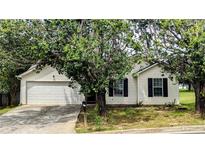 Charming single-story home with a well-maintained front yard and attached two-car garage at 7518 Edenberry Way, Lithonia, GA 30058