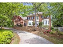 Traditional two-story brick home featuring bay windows and a well-manicured lawn at 3761 Bays Ferry Way, Marietta, GA 30062