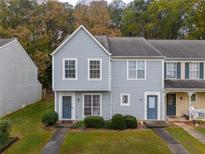 Charming townhome with a well-maintained lawn, blue siding, and a neatly landscaped front yard at 6711 Witherington Ct, Norcross, GA 30093