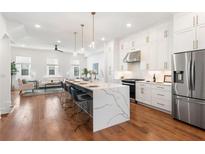 Bright, open kitchen featuring a large island with seating and stainless steel appliances at 1032 Robert Smalls Way, Atlanta, GA 30318