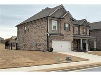 Beautiful two-story brick home with a two-car garage and well-maintained lawn at 3566 Andover Way, Buford, GA 30519
