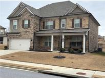 Charming two-story home with a covered front porch, brick and siding exterior, and a two-car garage at 3566 Andover Way, Buford, GA 30519