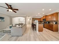 Open-concept living room with a ceiling fan and a view of the kitchen at 690 Cobblestone Creek Ln, Mableton, GA 30126