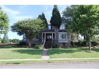 Charming two-story home with a brick stairway, landscaped front yard, and inviting front porch at 1699 Little Fox Ln, Dacula, GA 30019