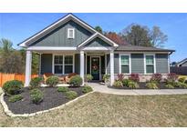 Inviting single story home with manicured lawn, charming front porch, and craftsman details at 34 Mountainbrook Nw Dr, Cartersville, GA 30121