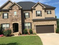 Beautiful two-story home with a well-maintained lawn, stone and brick facade and a two car garage at 292 Aylesbury Bv, Mcdonough, GA 30252
