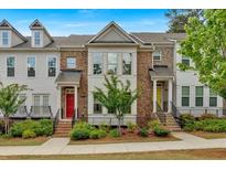 Charming brick townhouse with landscaped front yard, colorful door, and inviting curb appeal at 2066 Patterson Park Rd, Decatur, GA 30033