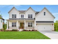 New construction home with a manicured lawn, covered porch, and a two-car garage at 4039 Tallow Pl, Woodstock, GA 30188