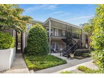 Exterior of a two-story brick building with staircases and balconies, surrounded by lush landscaping at 3675 Peachtree Ne Rd # 9, Atlanta, GA 30319