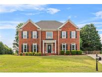 Charming two-story brick home featuring well-manicured landscaping and classic architectural details at 3720 Bridle Ridge Dr, Suwanee, GA 30024