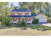 Charming two-story home with a welcoming front porch and beautiful landscaping at 4092 Deerbrook Sw Way, Lilburn, GA 30047