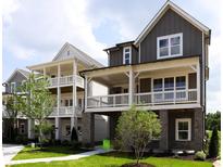 Charming new construction townhouse with inviting double porches and well-manicured landscaping at 1415 Coretta Bnd, Atlanta, GA 30318