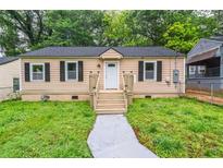 Charming single-story home with tan siding, black shutters, and a well-maintained front yard at 1482 Connally Sw Ave, Atlanta, GA 30310