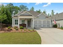 Charming one-story home with manicured lawn and cozy front porch seating at 52 Lantern Trce, Hiram, GA 30141