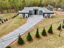 Stunning modern home with unique architectural design, manicured lawn, and long concrete driveway at 0 Highway 279, Fayetteville, GA 30214