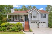 Charming two-story home with a welcoming front porch and a well-manicured lawn at 31 Fairview Oak Cv, Dallas, GA 30157