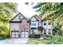 Charming home with a well-maintained lawn, stone accents, and a two-car garage at 1897 8Th St, Atlanta, GA 30341