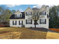 Traditional two-story home with white stucco, black shutters, and a well-maintained front lawn at 360 Wynbrook Dr, Mcdonough, GA 30253