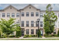 Inviting townhome exterior featuring a combination of stone and siding with a well-manicured lawn at 2048 Rockledge Ne Rd, Atlanta, GA 30324