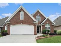 Beautiful brick home with a well-manicured lawn and a two-car garage, offering classic curb appeal at 2050 Woodberry Run Dr, Snellville, GA 30078