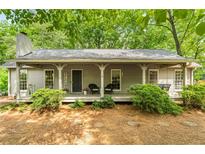 Charming home featuring a cozy front porch with rocking chairs, and a beautifully landscaped yard at 258 Lancaster Cir, Marietta, GA 30066