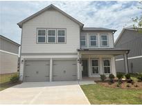 Charming two-story home featuring a two-car garage and neatly manicured lawn at 2093 Boxwood Se Cir, Conyers, GA 30094