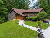 Charming home with gray siding, brown roof, and a delightful landscaped front yard at 2674 Skylane Dr, Marietta, GA 30062