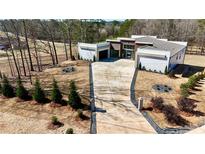 Stunning modern home featuring a long driveway, meticulously landscaped yard and a sleek three car garage at 292 Highway 279, Fayetteville, GA 30214