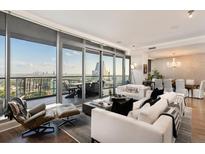 Bright, open living room with floor-to-ceiling windows and access to a large outdoor balcony with city views at 3344 Peachtree Ne Rd # 3005, Atlanta, GA 30326