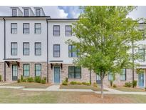 Charming painted brick townhouse with front yard and tree at 1117 Larkin Dr, Buford, GA 30518
