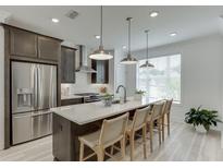 Modern kitchen features stainless steel appliances, a large island, pendant lighting, and ample counter space at 1117 Larkin Dr, Buford, GA 30518
