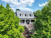Charming two-story home with a welcoming front porch and beautifully landscaped surroundings at 10559 Serenbe Ln, Chattahoochee Hills, GA 30268