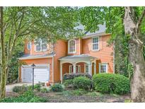 Charming two-story home with manicured landscaping, a welcoming front porch and a two car garage at 1259 Crescentwood Ln, Decatur, GA 30032