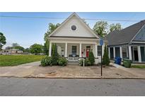 Charming home featuring a classic white exterior, inviting front porch, and beautifully landscaped yard at 224 Bass Sw St, Atlanta, GA 30315