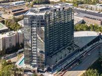 Stunning high-rise building featuring modern glass architecture, a pool, and a convenient parking deck at 788 W Marietta Nw St # 905, Atlanta, GA 30318